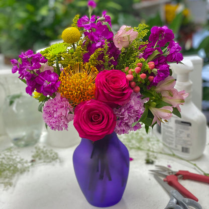 Send flowers to Coral Gables with this colorful bouquet of flowers in a purple vase.  Flower shop in Coral gables for flower delivery Coral Gables