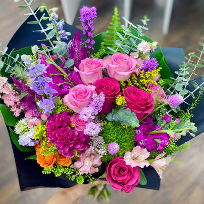Bouquet of colorful flowers including pink and purple roses, greenery, and other assorted flowers for delivery in Miami Beach