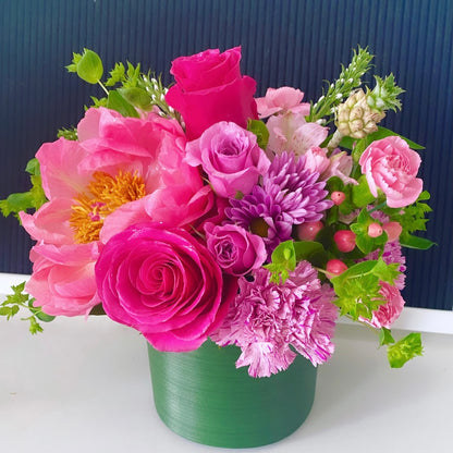Colorful flower arrangement with roses, peonies, and pineapple accents. Floral arrangement to be delivered in Miami Beach
