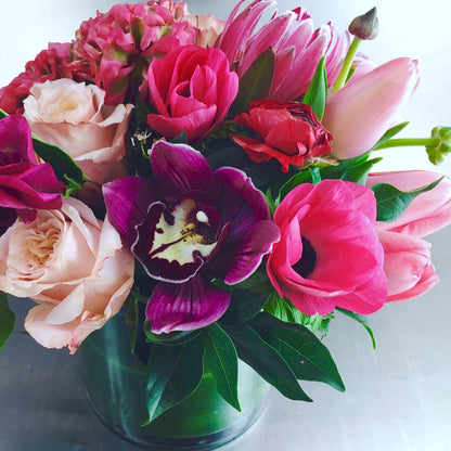 Bouquet of colorful flowers including pink, red, and purple blooms in a clear vase from Miami Beach flower shop