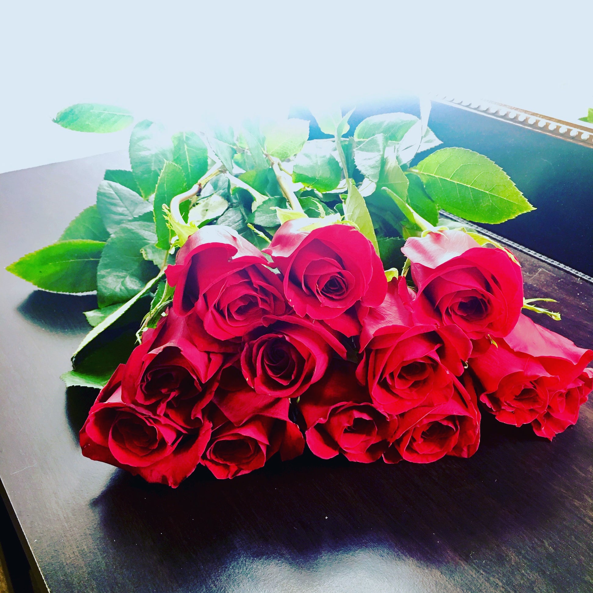 Bouquet of red roses on a dark surface for delivery in Miami flower shop